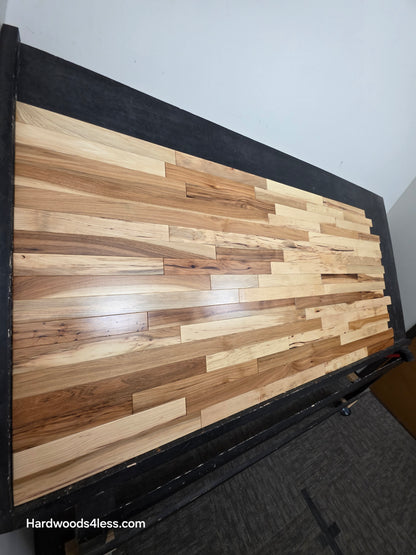 2 1/4" x 3/4" Hickory Natural Character Grade Hardwood Flooring.  Shown on a black shooting table shot from the left hand side. 