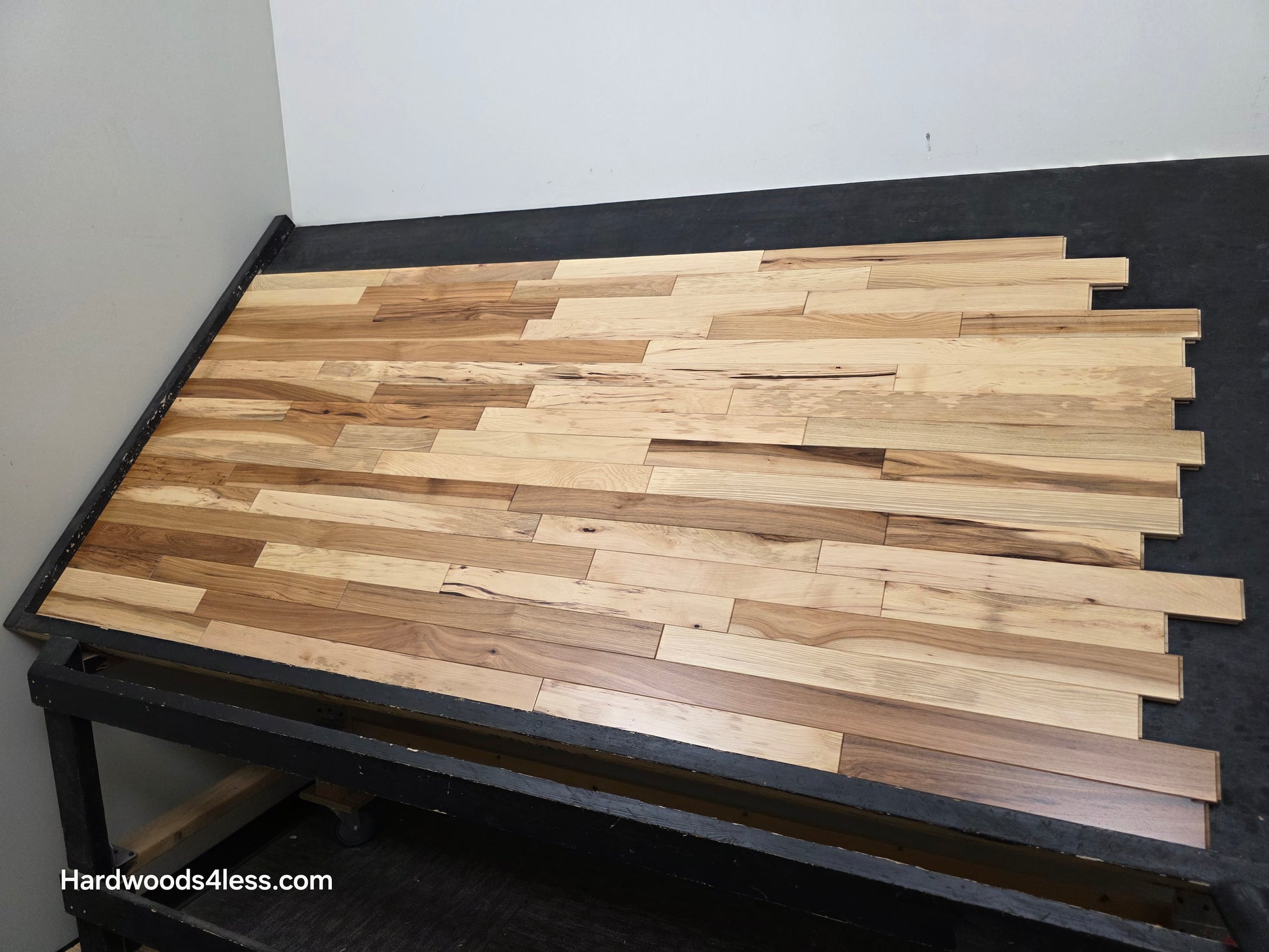 2 1/4" x 3/4" Hickory Natural Character Grade Hardwood Flooring. Shown on a black shooting table. Right hand shot. 