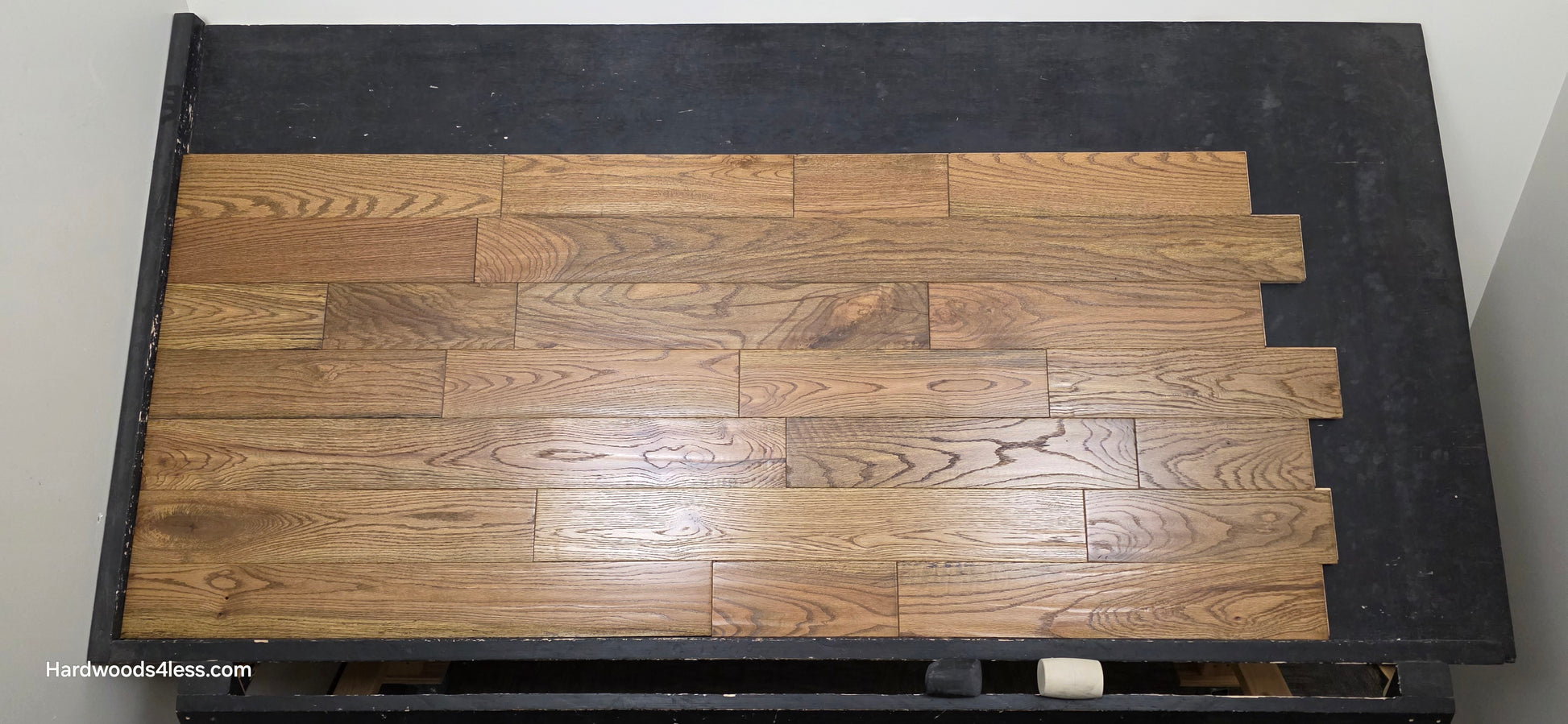 Solid Red Oak Purslane Hardwood Flooring shown on a black shooting rack shot from center