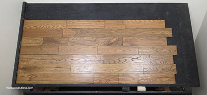 Solid Red Oak Purslane Hardwood Flooring shown on a black shooting rack shot from center