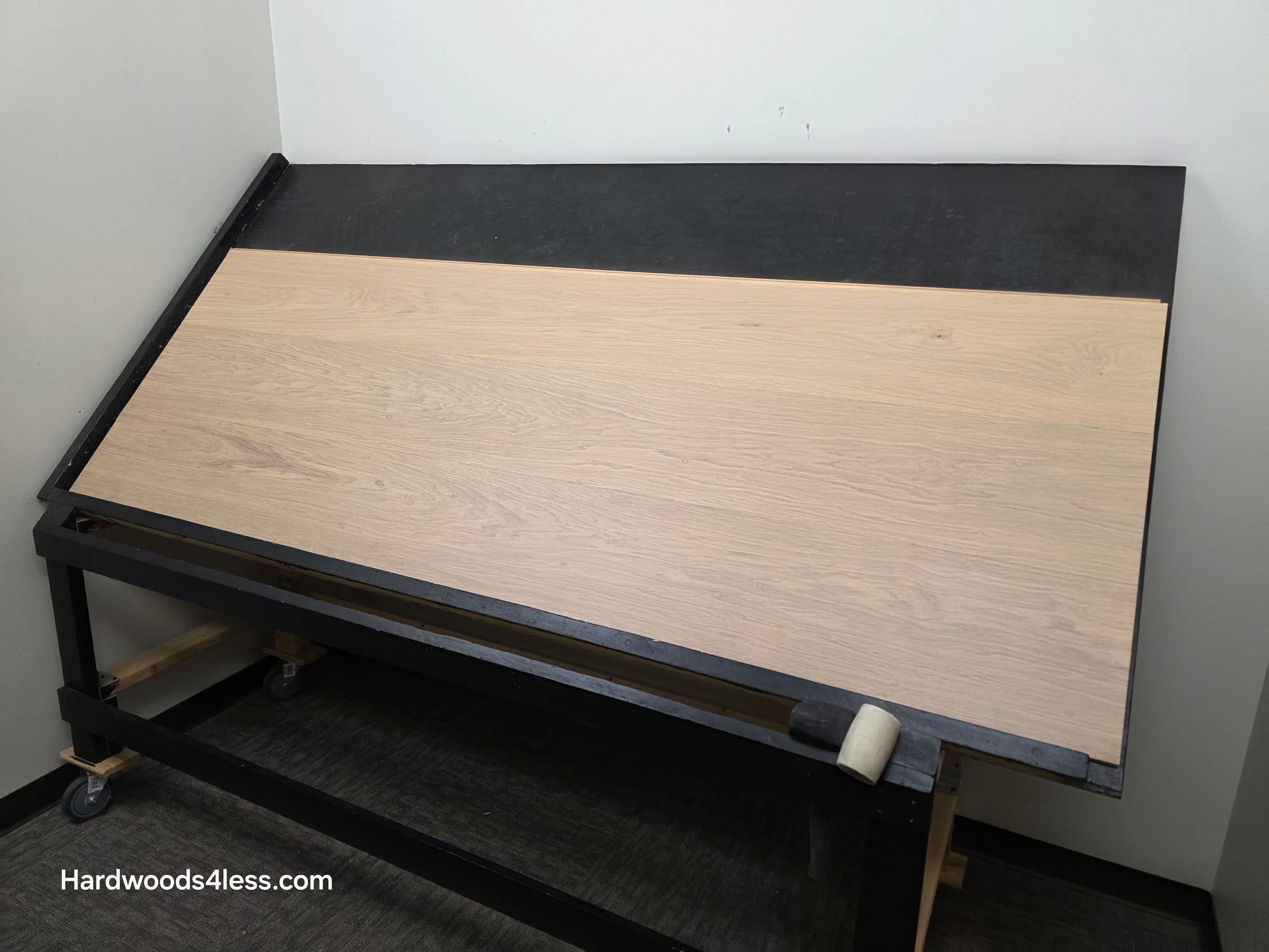 10.67" x 7/16" Modernized Engineered European Oak Gropius Hardened Hardwood Flooring. Shown on a black shooting table. Shot from wide right. 