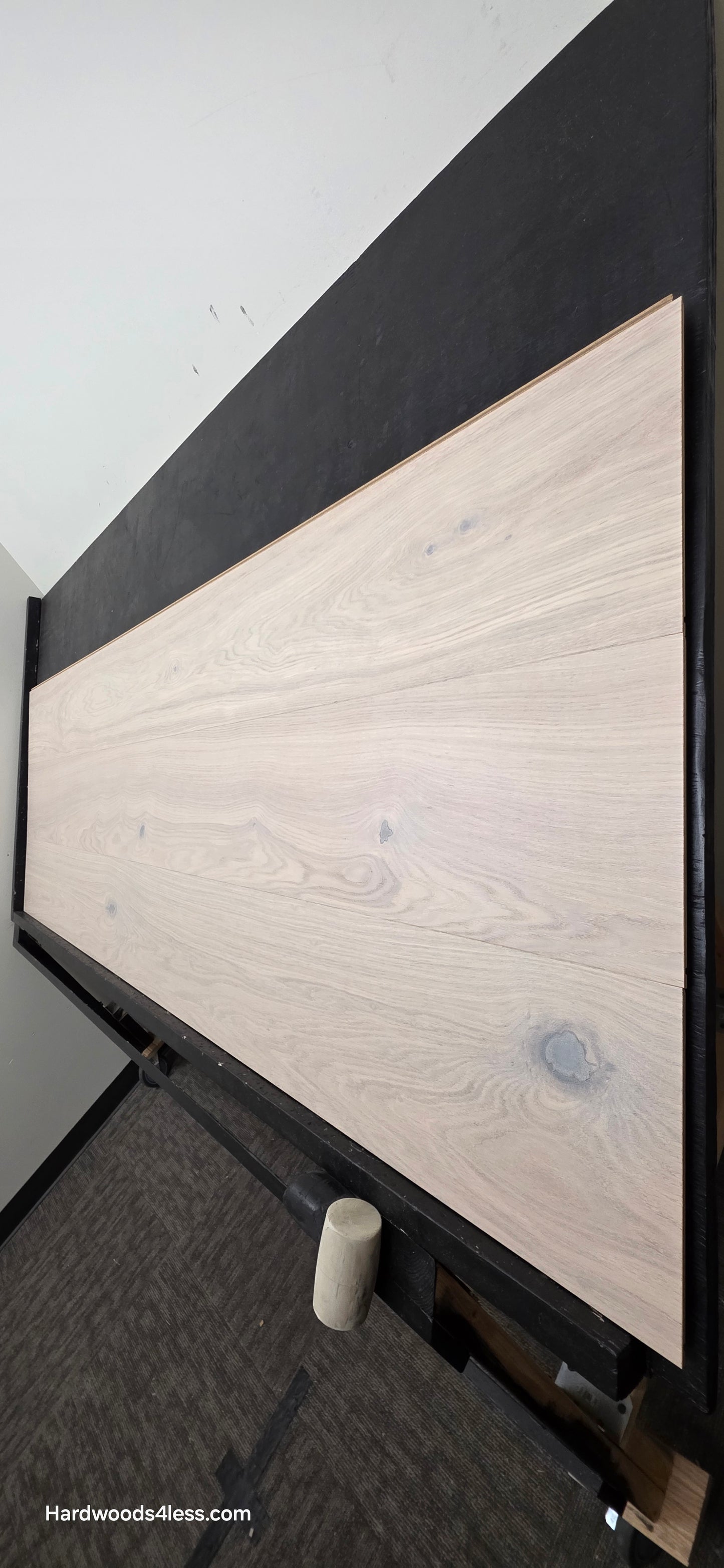10.67" x 7/16" Modernized Engineered European Oak Corbusier Hardened Hardwood Flooring. Shown on a black shooting table. Shot from steep right.