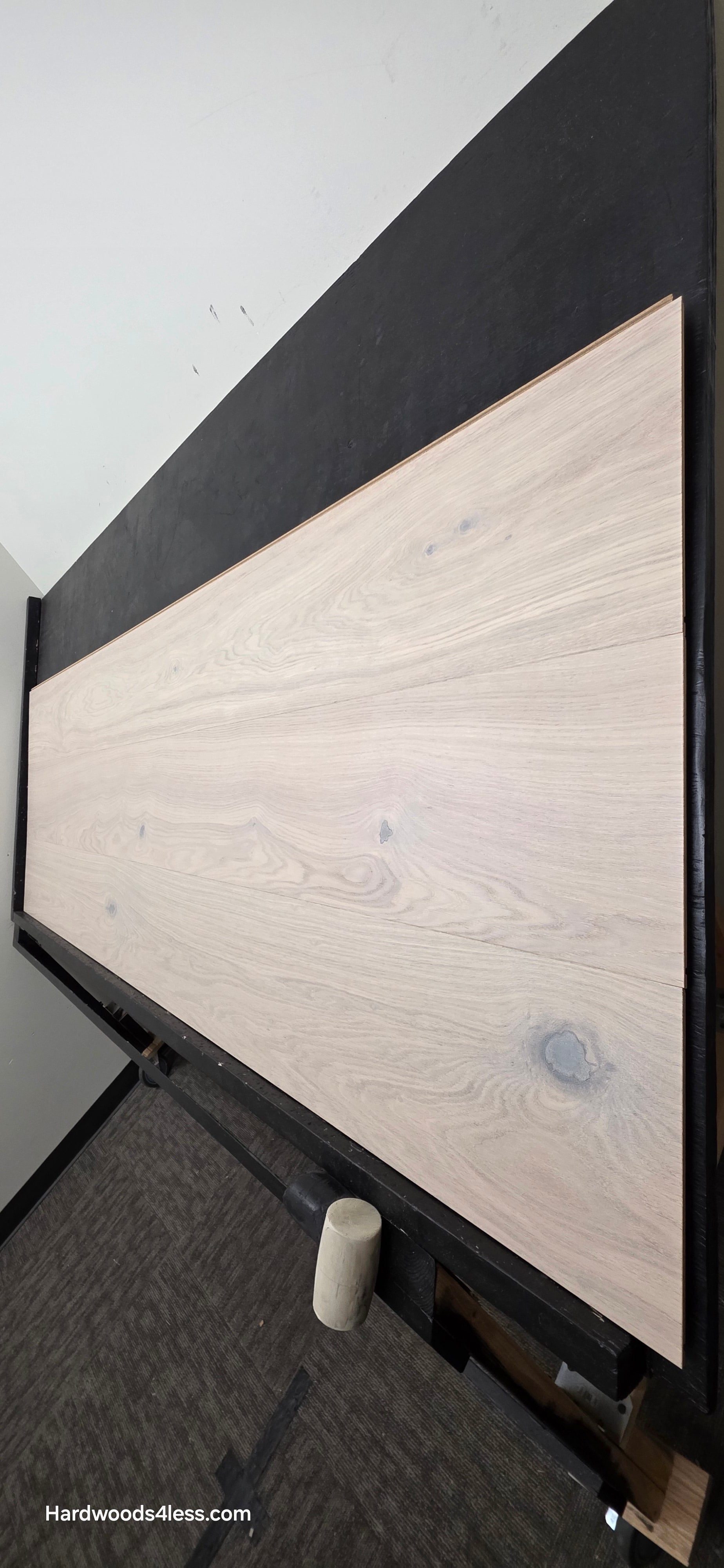 10.67" x 7/16" Modernized Engineered European Oak Corbusier Hardened Hardwood Flooring. Shown on a black shooting table. Shot from steep right.