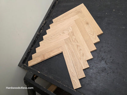 2 14 x 15.75 x 34 Solid Unfinished White Oak Herringbone Hardwood Flooring. Shown on a black shooting table. Shot from Center right.