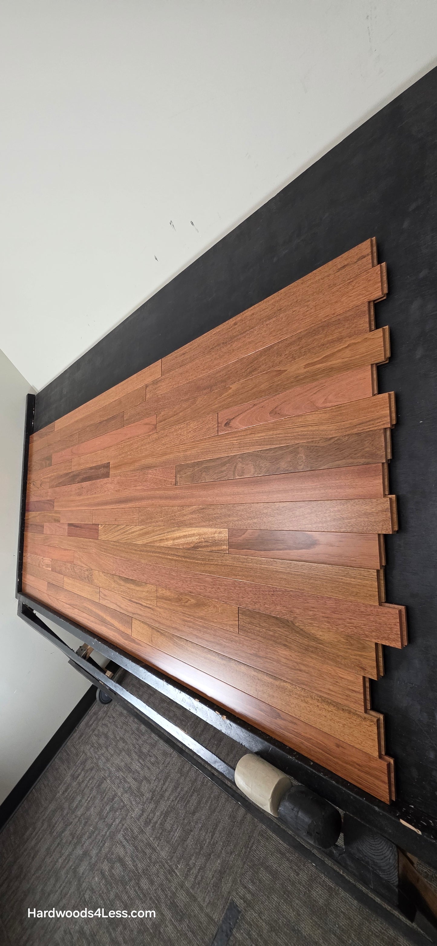 2 1/4" x 3/4" Brazilian Cherry Hardwood Flooring. Shown on a black shooting table. Shot from steep right.