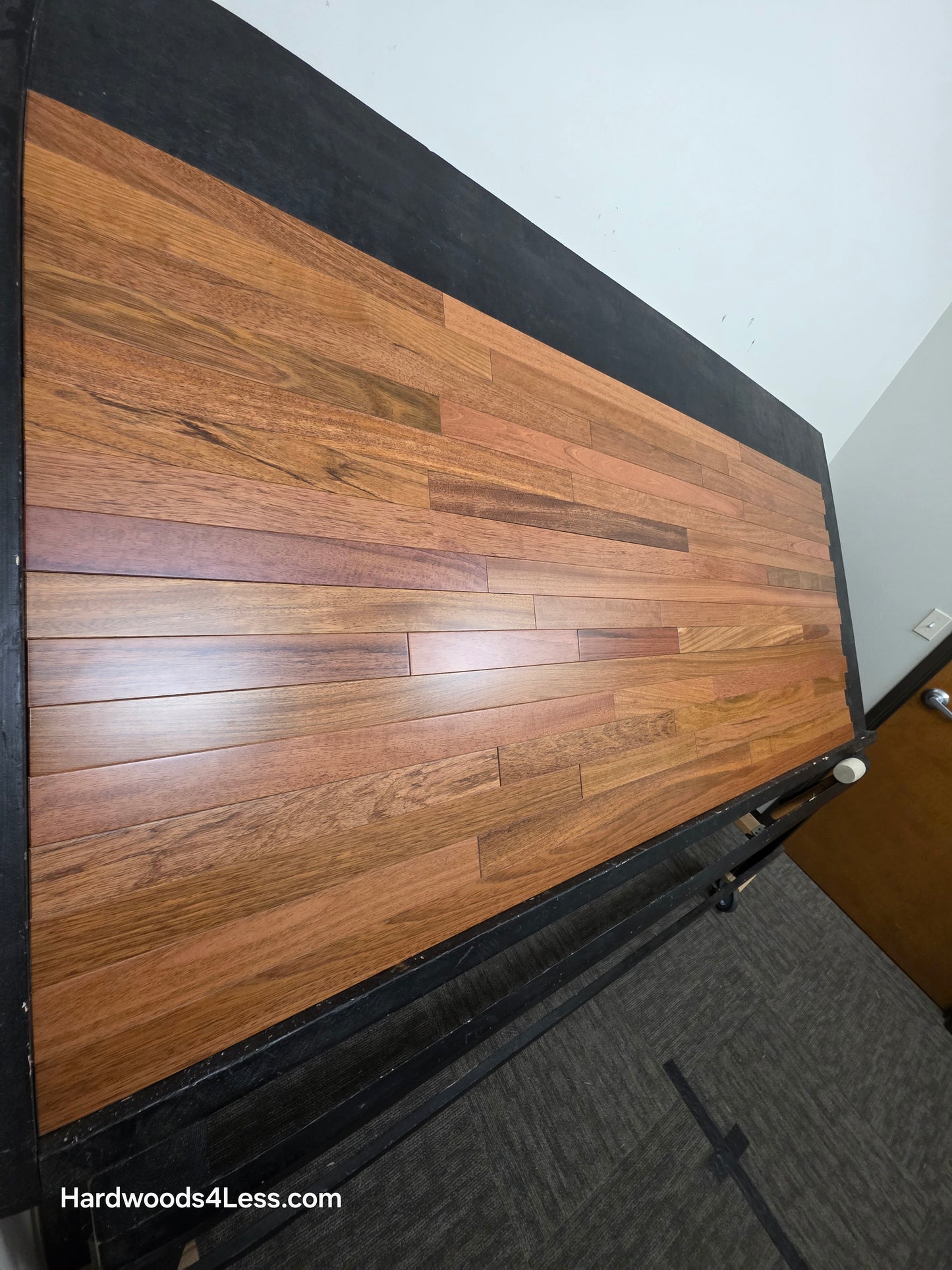 2 1/4" x 3/4" Brazilian Cherry Hardwood Flooring. Shown on a black shooting table. Shot from steep left. 