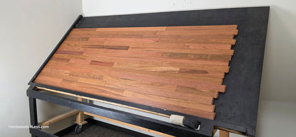 2 1/4" x 3/4" Brazilian Cherry Hardwood Flooring. Shown on a black shooting table. Shot from wide right.
