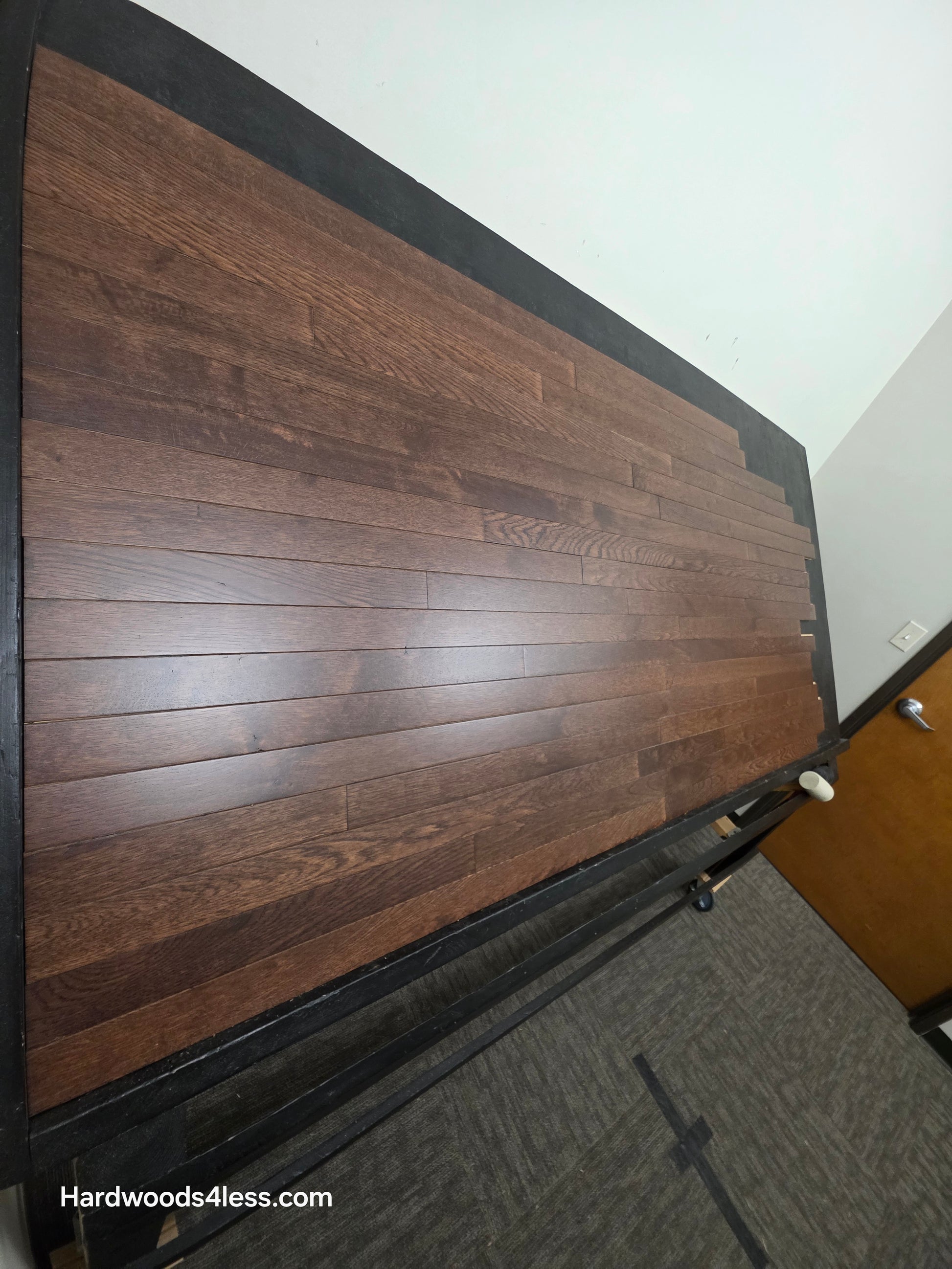 2 1/4" x 3/4" Solid Oak Modica Hardwood Flooring. Shown on a black shooting table. Shot from steep left.  
