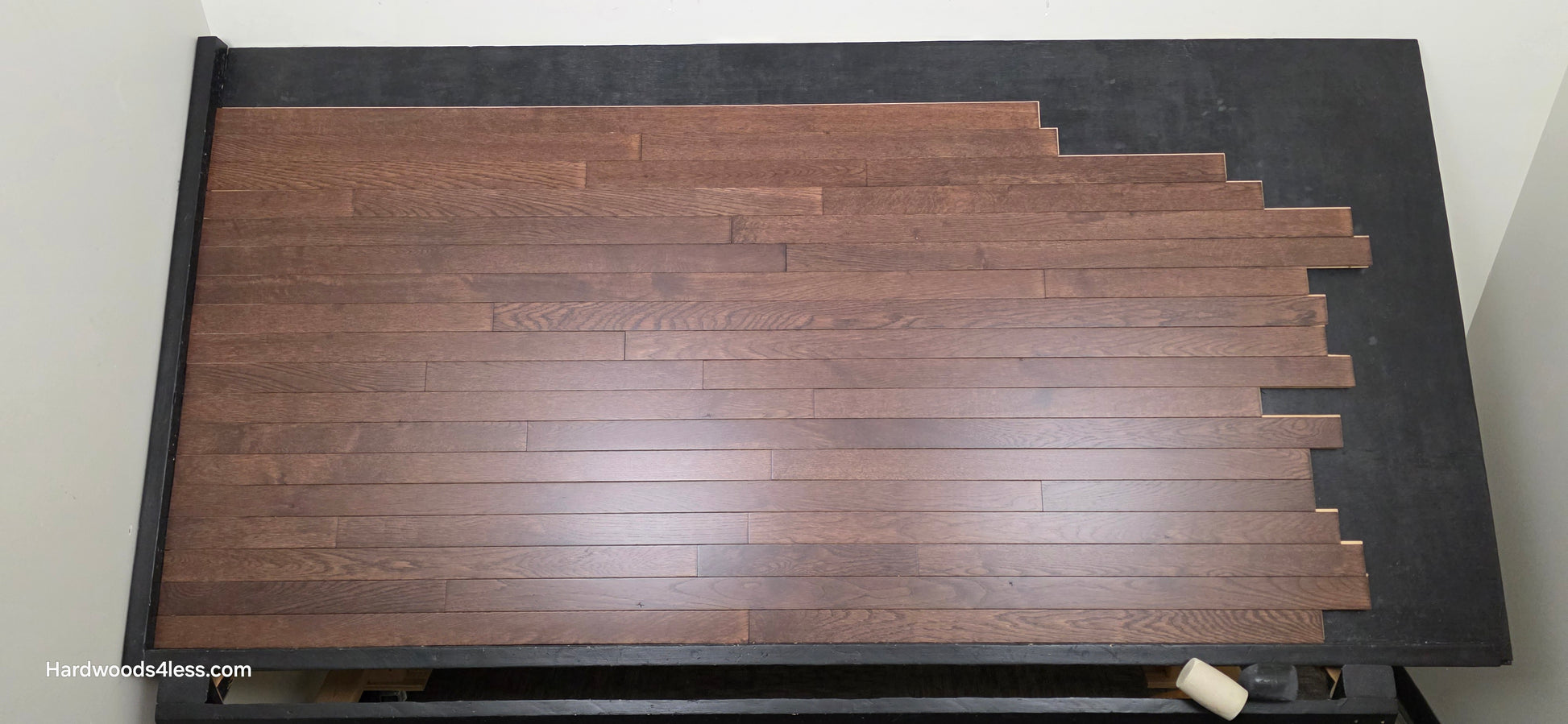 2 1/4" x 3/4" Solid Oak Modica Hardwood Flooring. Shown on a black shooting table. Shot from center. 