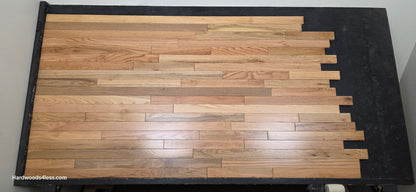 2 1/4" x 3/4" Solid Red Oak Natural Mill Run Hardwood Flooring Shown on a black shooting table. Shot from center. 