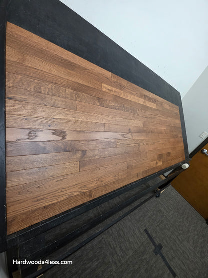 2 1/4" x 3/4" White Oak Gunstock Hardwood Flooring. Shown on a black shooting table. Shot from tight left.