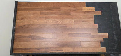 3 1/4", 4", 5" Mixed Width Engineered Hickory Regal Helm Hardwood Flooring. Shown on a black shooting table. Center shot.