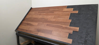 3 1/4", 4", 5" Mixed Width Engineered Hickory Regal Helm Hardwood Flooring. Shown on a black shooting table. Shot from the right hand side. 