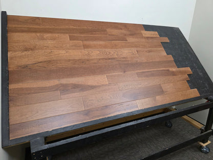 3 1/4", 4", 5" Mixed Width Engineered Hickory Regal Helm Hardwood Flooring. Shown on a black shooting table. Steep left side shot. 