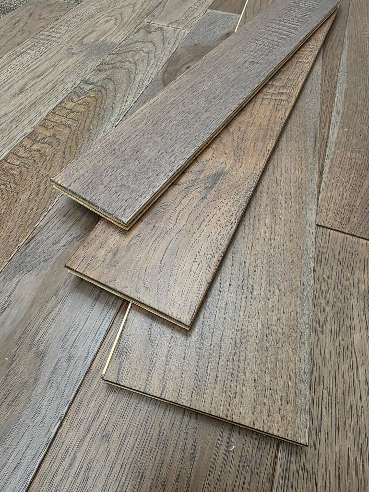 3 1/4", 4", 5" Mixed Width Engineered Hickory Windlass Hardwood Flooring. Three stacked atop each other. 