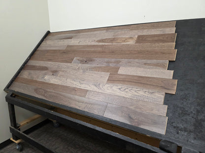 3 1/4", 4", 5" Mixed Width Engineered Hickory Windlass Hardwood Flooring. Shown on a Black shooting table. Shot wide on the right side. 