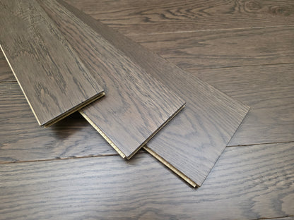 3 1/4", 4", 5" Mixed Width Engineered White Oak Transom Hardwood Flooring. Three planks are shown stacked on top of the floor at an angle. 