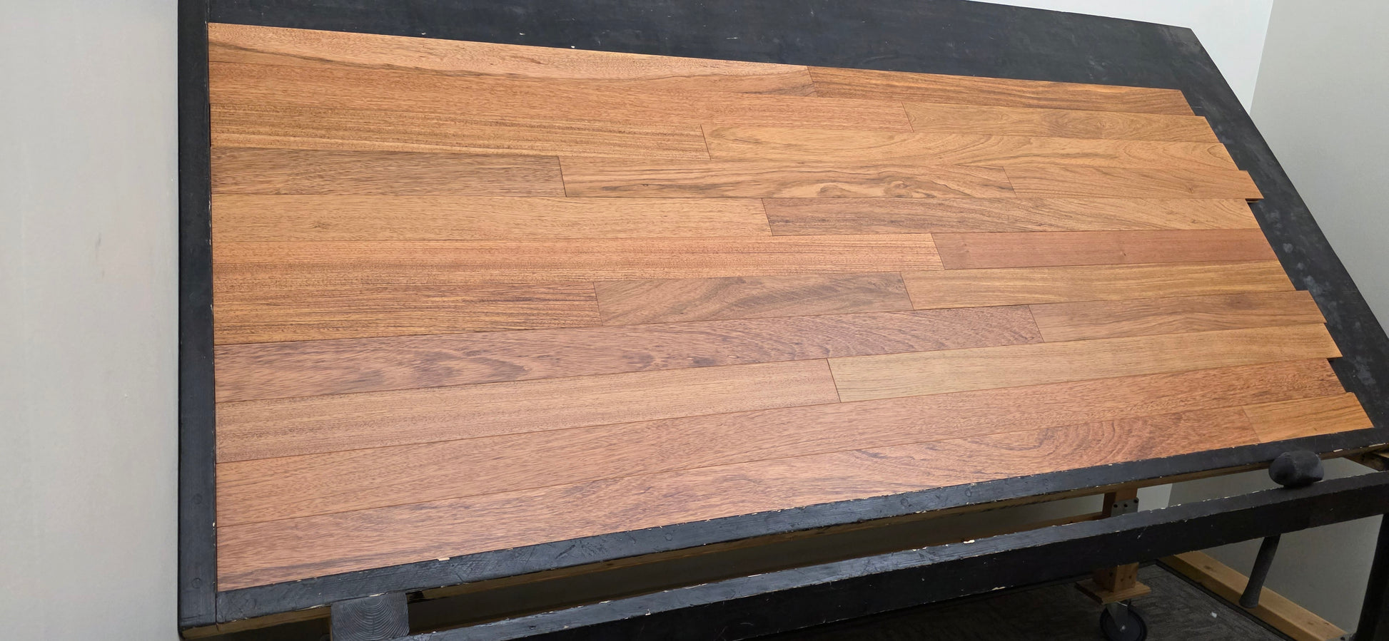 3 1/4" x 3/4" Brazilian Cherry Matte Prefinished Hardwood Flooring. Shown on a black shooting table. Left hand shot. 
