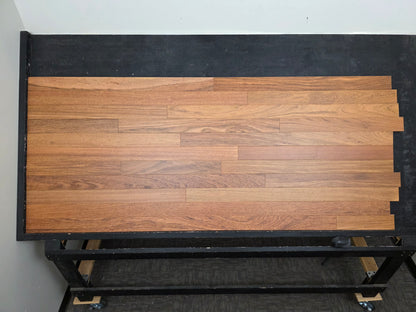 3 1/4" x 3/4" Brazilian Cherry Matte Prefinished Hardwood Flooring. Shown on a black shooting table. Center shot.