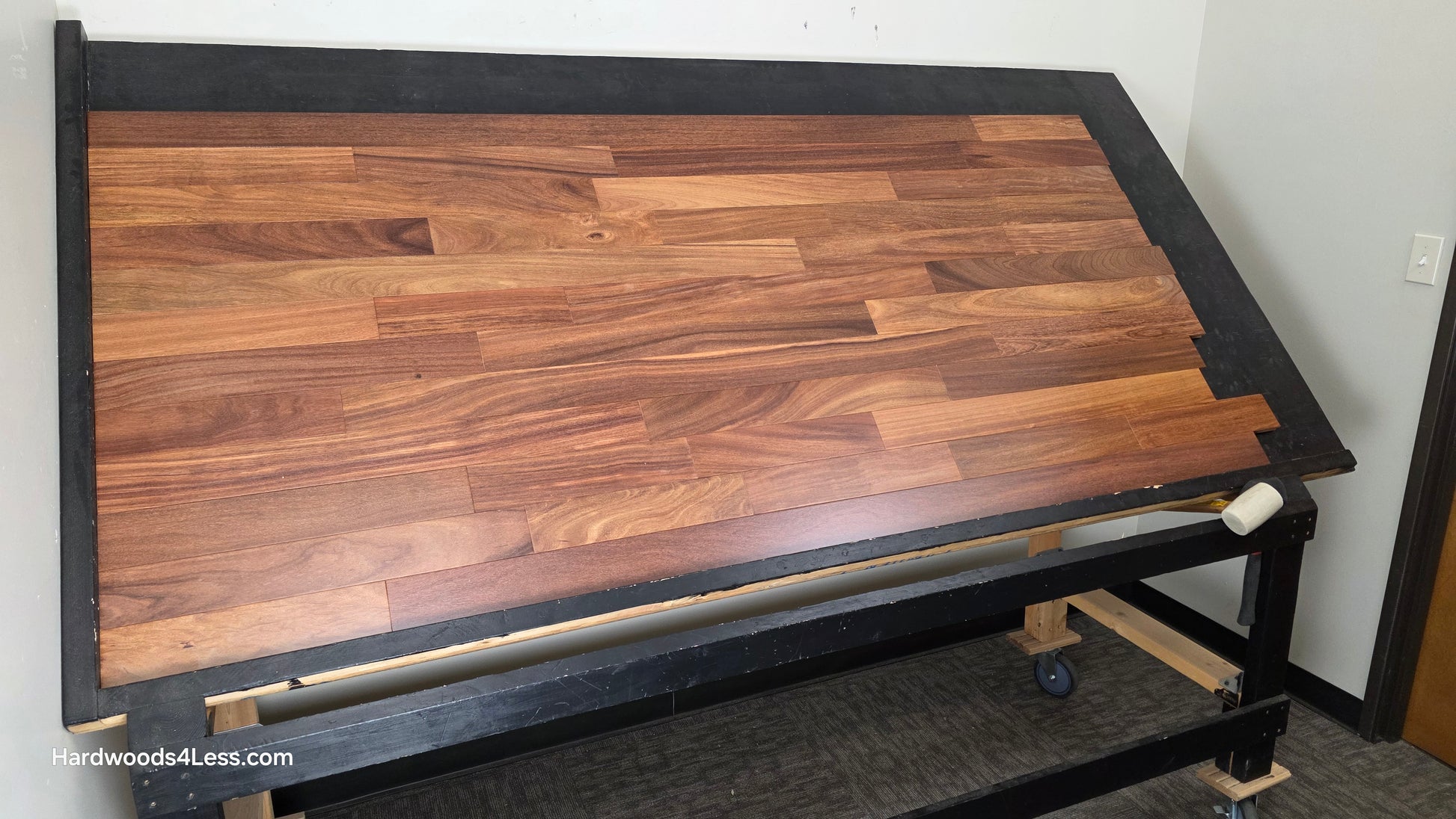 3 1/4" x 3/4" Brazilian Red Teak (Cumaru) Hardwood Flooring. Shown on a black shooting table. Shot from wide left.