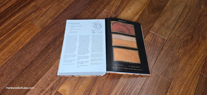 3 1/4" x 3/4" Brazilian Red Teak (Cumaru) Hardwood Flooring. At center is a hardwood book opened to a random page. Under the book is the Brazilian cherry flooring.