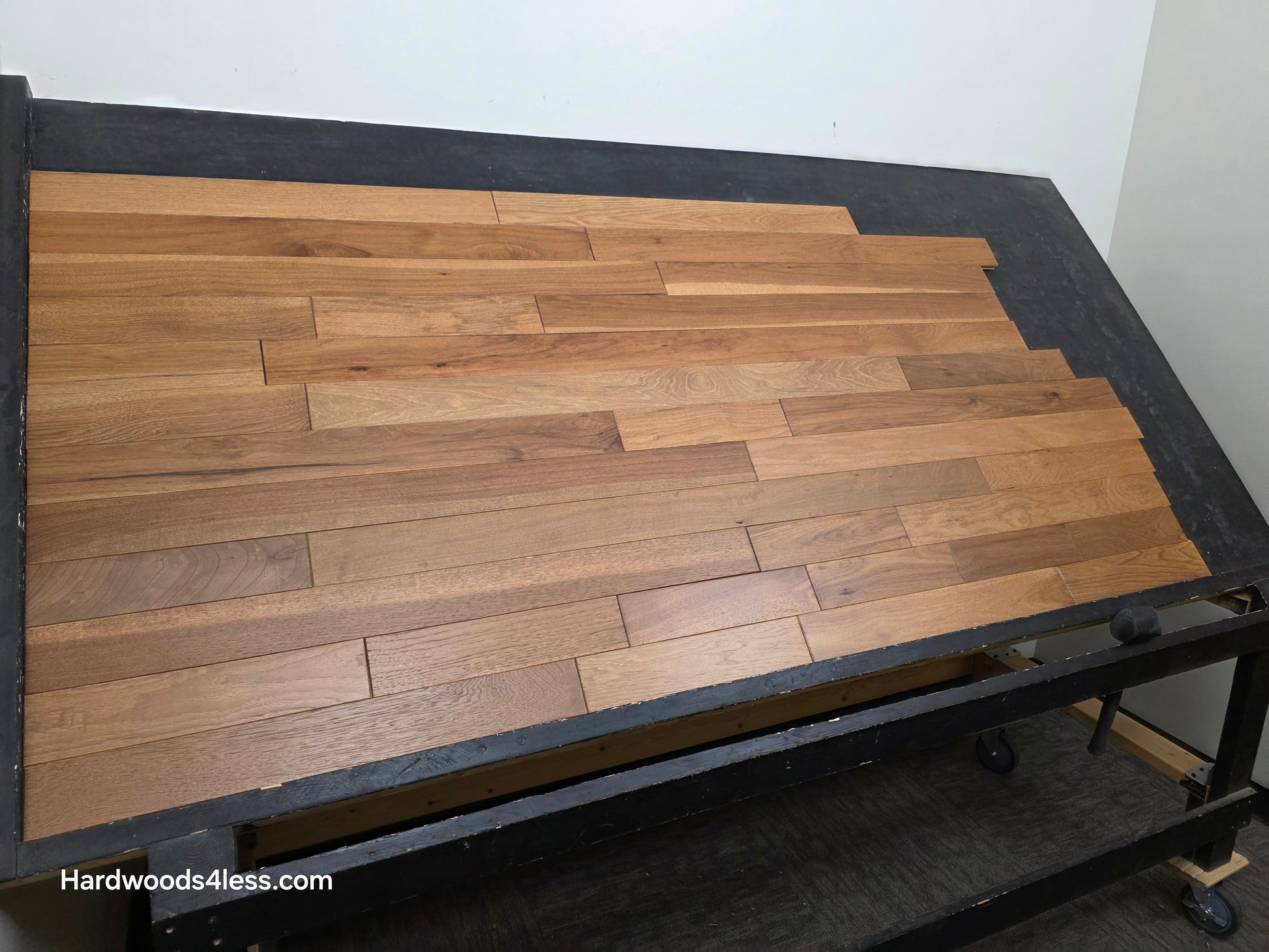 3 1/4" x 3/4" Hickory Molasses Character Grade Hardwood Flooring. Shown on a black shooting table. Shot from the Left hand side.