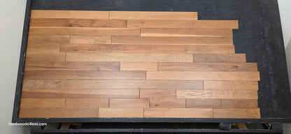 3 1/4" x 3/4" Hickory Molasses Character Grade Hardwood Flooring. Shown on a black shooting table. Center shot.