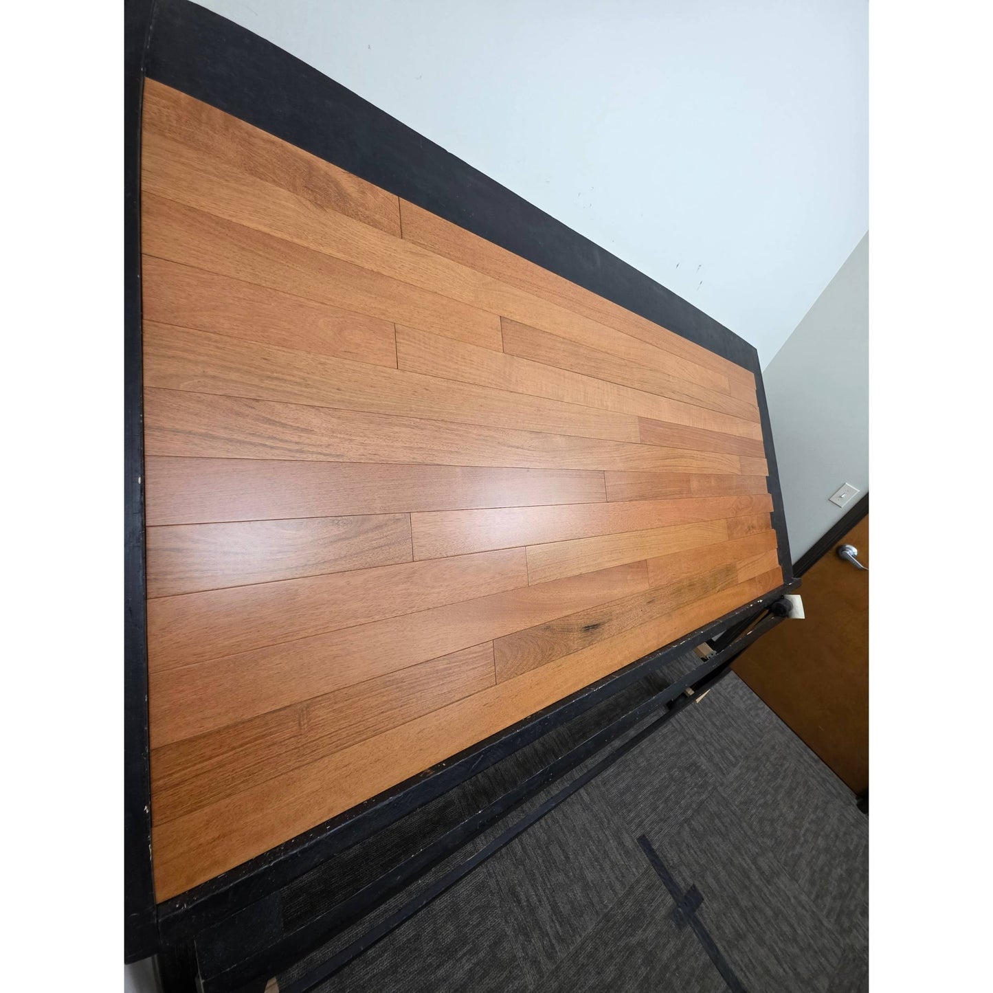 3 1/4" x 3/4" Prefinished Brazilian Cherry Shorts Hardwood Flooring shown on a black shooting table Shot from steep left. 