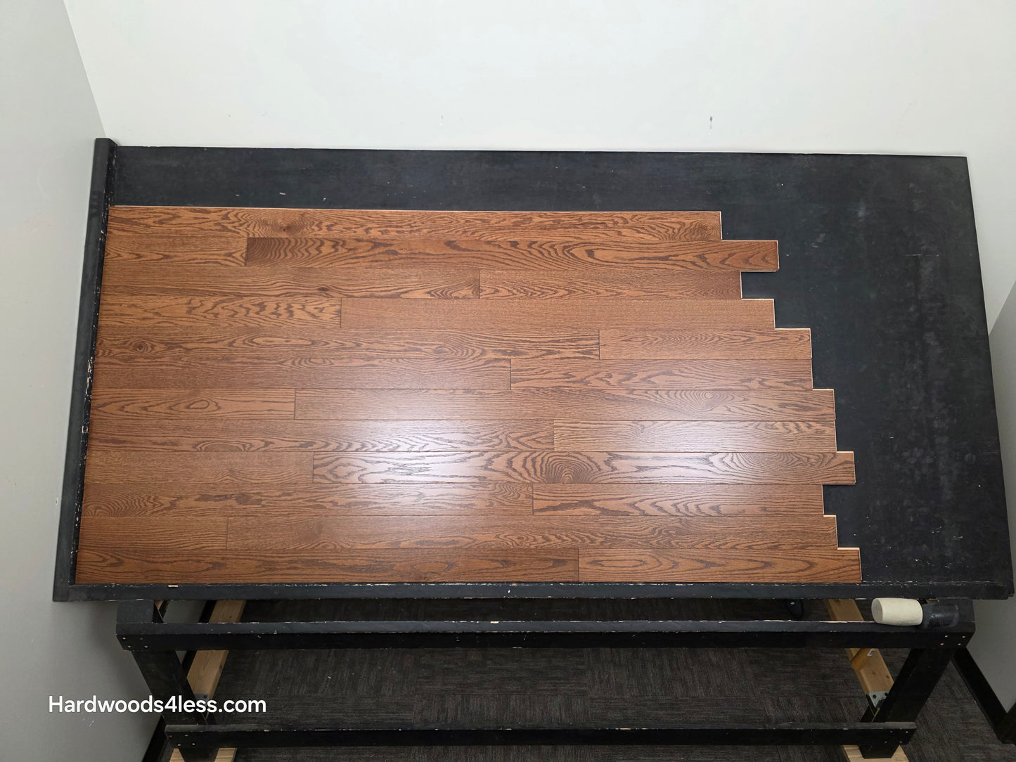 3 1/4" x 3/4" Red Oak Butterscotch Common & Better Hardwood Flooring. Shown on a black shooting table. Shot from center.