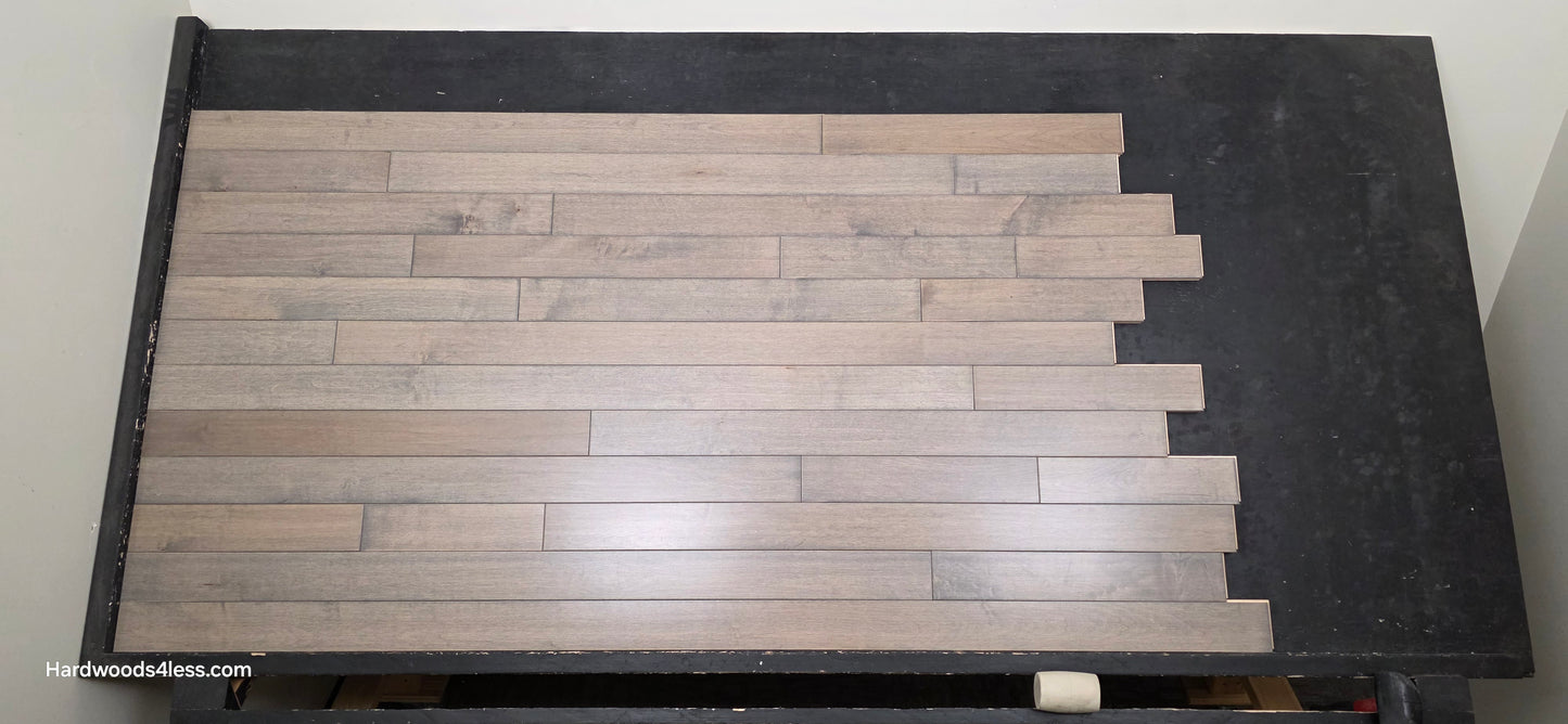 3 1/4" x 3/4" Solid Maple Dove Hardwood Flooring. Shown on a black shooting table. shot from center. 