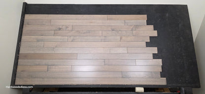 3 1/4" x 3/4" Solid Maple Dove Hardwood Flooring. Shown on a black shooting table. shot from center. 