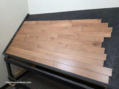 3 1/4" x 3/4" Solid Maple Haystack Hardwood Flooring. Shown on a black shooting table. Shot from close right.