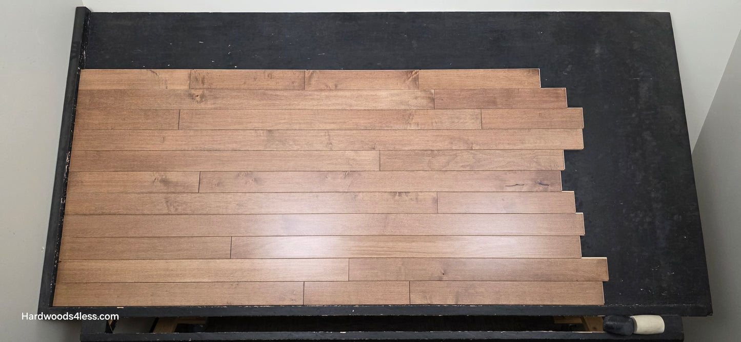 3 1/4" x 3/4" Solid Maple Haystack Hardwood Flooring. Shown on a black shooting table. Shot from center.