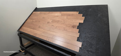 3 1/4" x 3/4" Solid Maple Haystack Hardwood Flooring. Shown on a black shooting table. Shot from wide right.