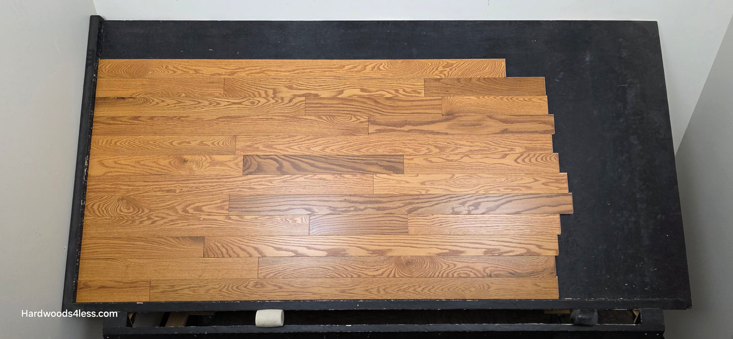 3 14 x 34 Solid Red Oak Blake Hardwood Flooring. Shown on a black shooting table shot from center.