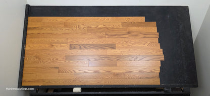 3 14 x 34 Solid Red Oak Blake Hardwood Flooring. Shown on a black shooting table shot from center.