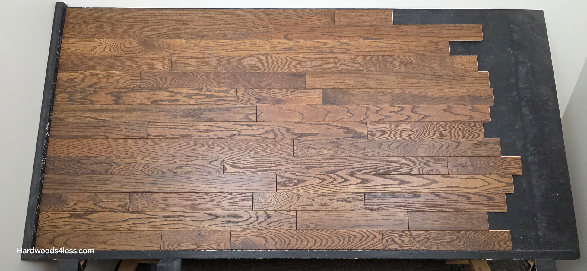 3 1/4" x 3/4" Solid Red Oak Bronze Hardwood Flooring. Shown on a black shooting table. Center shot.