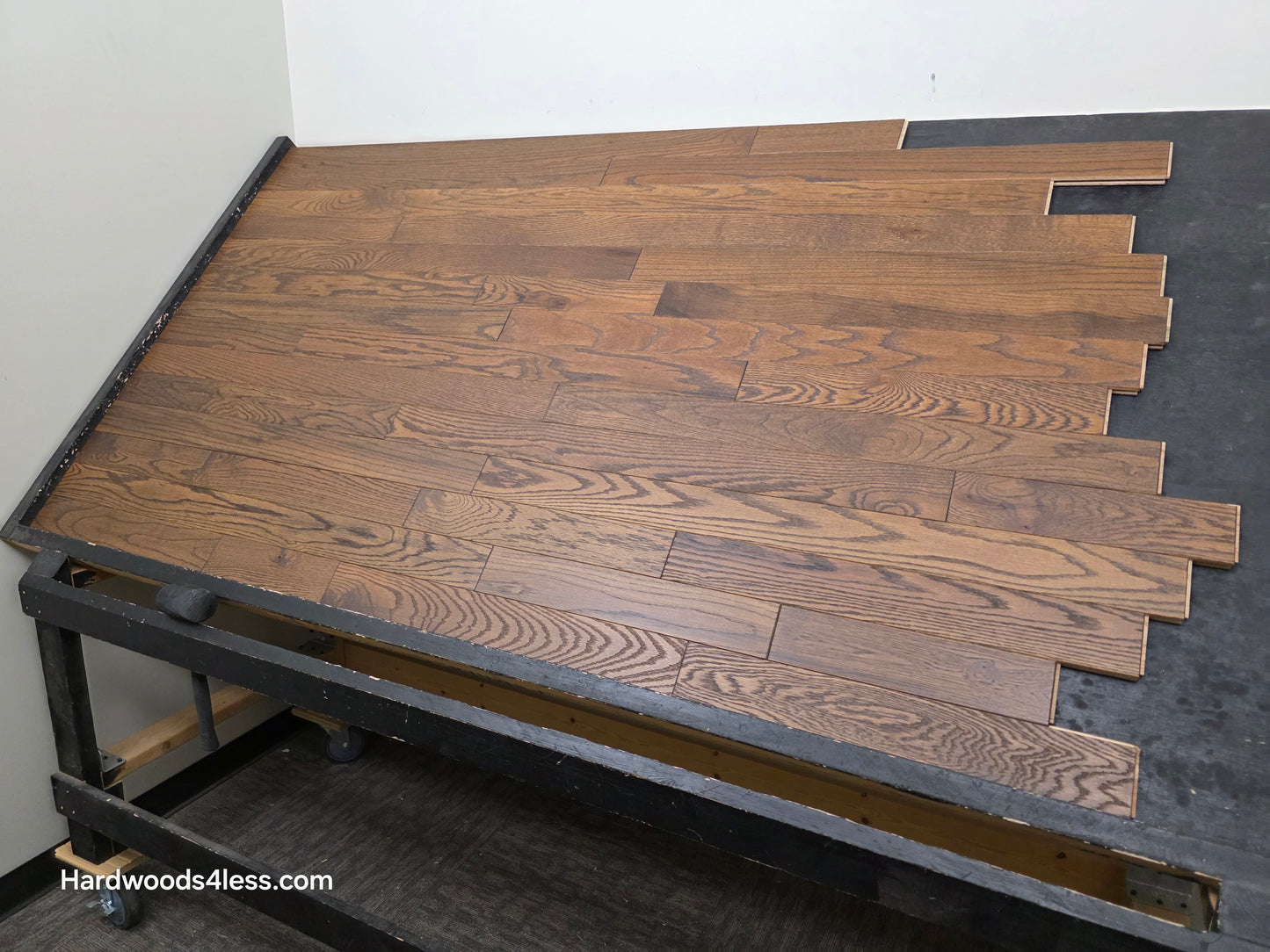 3 1/4" x 3/4" Solid Red Oak Bronze Hardwood Flooring. Shown on a black shooting table. Shot from wide right.