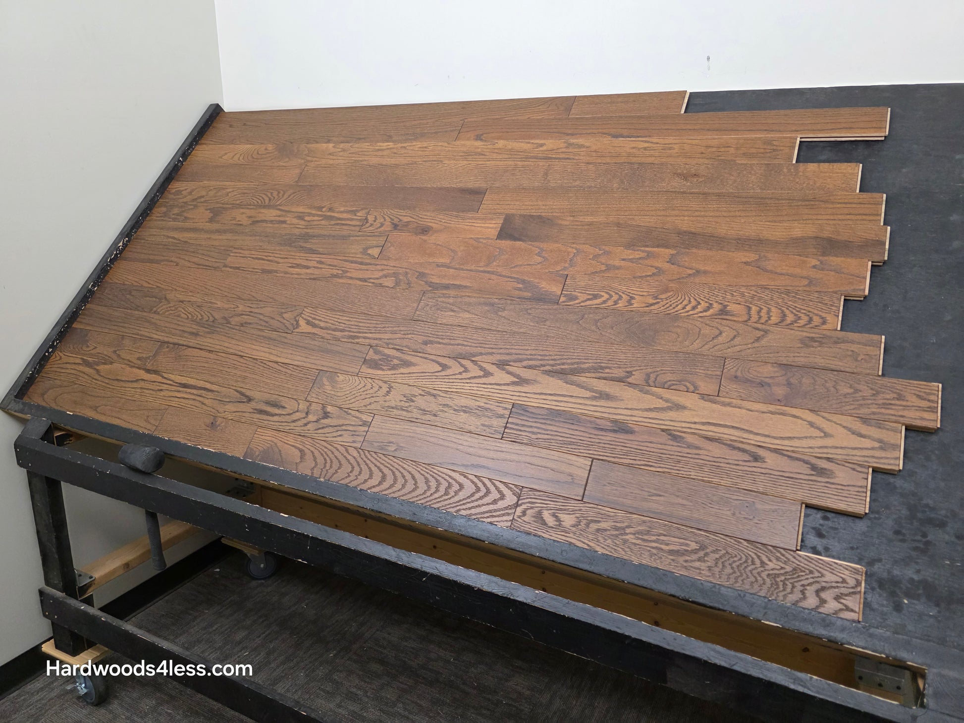 3 1/4" x 3/4" Solid Red Oak Bronze Hardwood Flooring. Shown on a black shooting table. Shot from wide right.