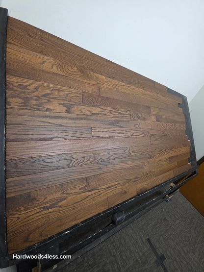 3 1/4" x 3/4" Solid Red Oak Bronze Hardwood Flooring. Shown on a black shooting table. Shot from steep left. 
