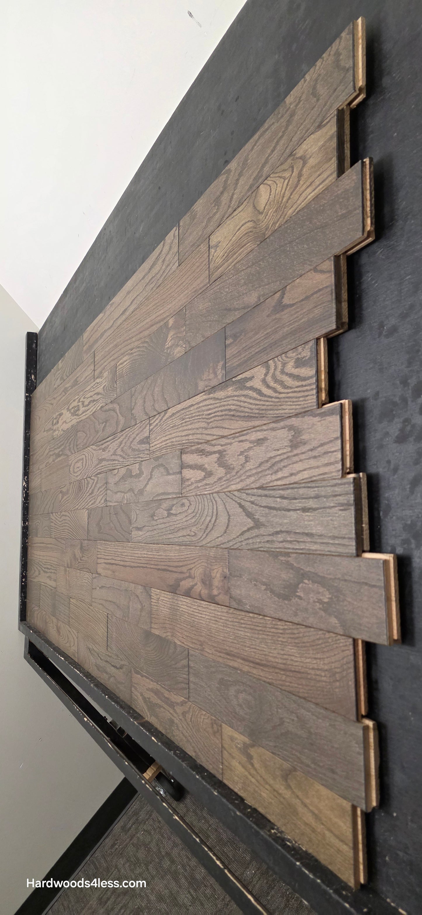 3 1/4" x 3/4" Solid Red Oak Coal Hardwood Flooring. Shown on a black shooting table. shot steep right. 