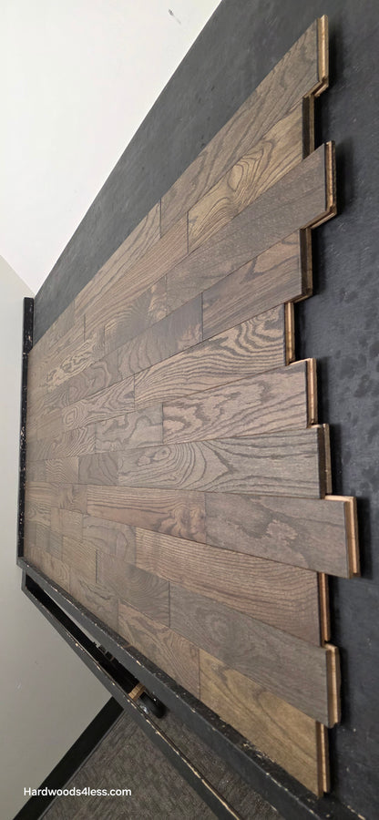 3 1/4" x 3/4" Solid Red Oak Coal Hardwood Flooring. Shown on a black shooting table. shot steep right. 