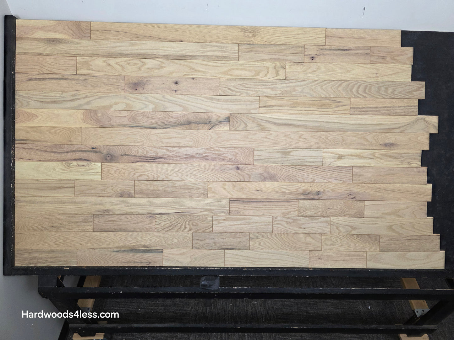 3 1/4" x 3/4" Solid Red Oak Khaki Hardwood Flooring. Shown on a black shooting table. Shot from center.