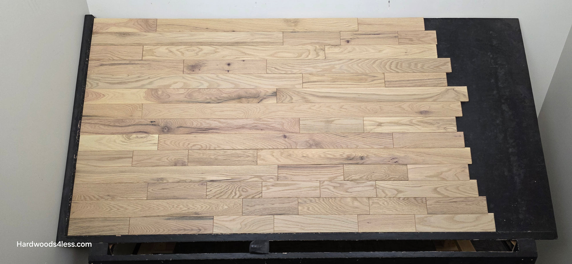 3 1/4" x 3/4" Solid Red Oak Khaki Hardwood Flooring. Shown on a black shooting table. Shot from center.