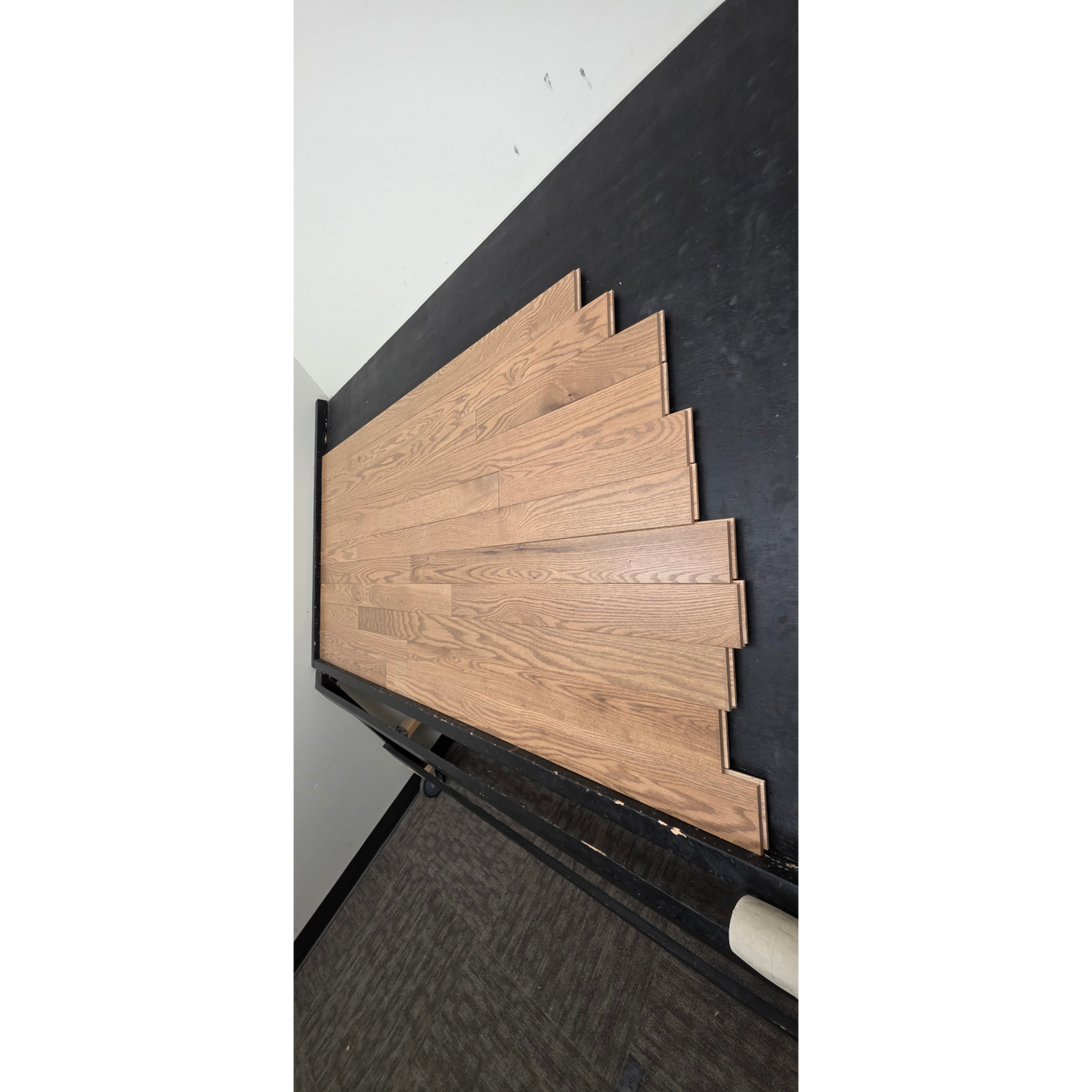 3 1/4" x 3/4" Solid Red Oak Marcy Hardwood Flooring. Shown on a black shooting table. Shot from steep right.