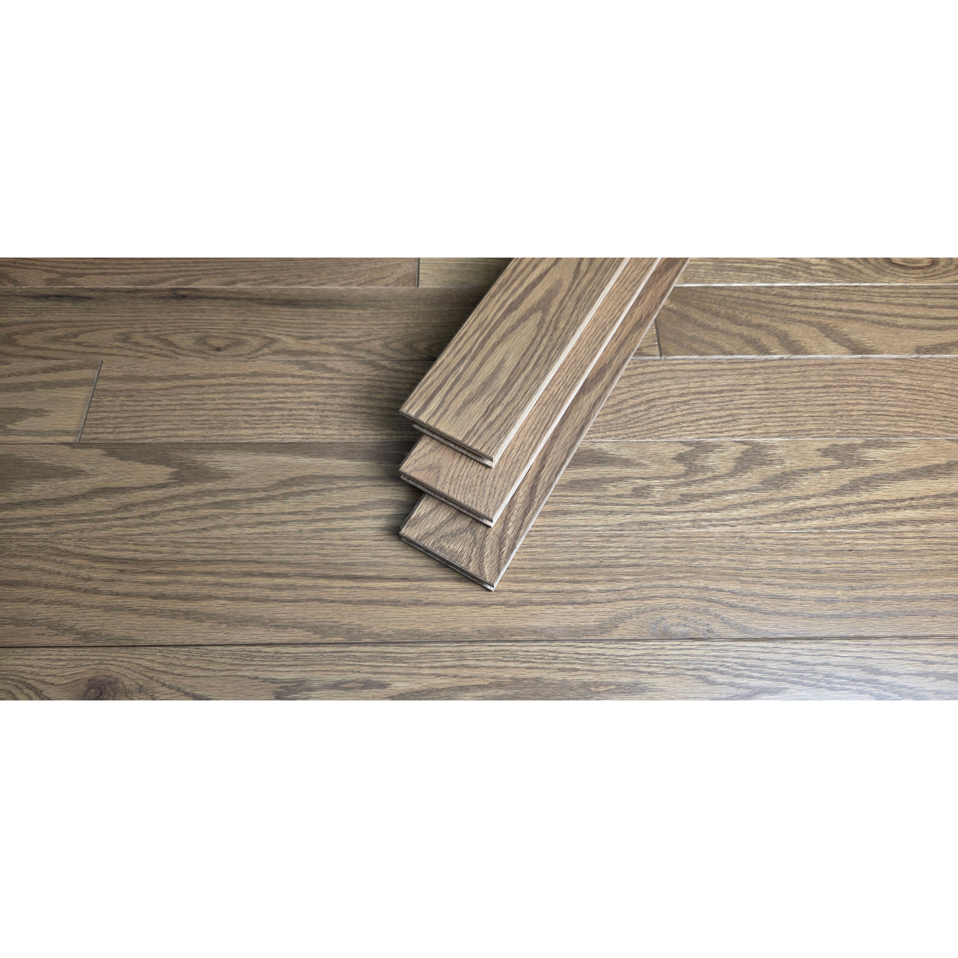 3 1/4" x 3/4" Solid Red Oak Marcy Hardwood Flooring. Shown close up with three planks of the Flooring stacked at center of the floor. 