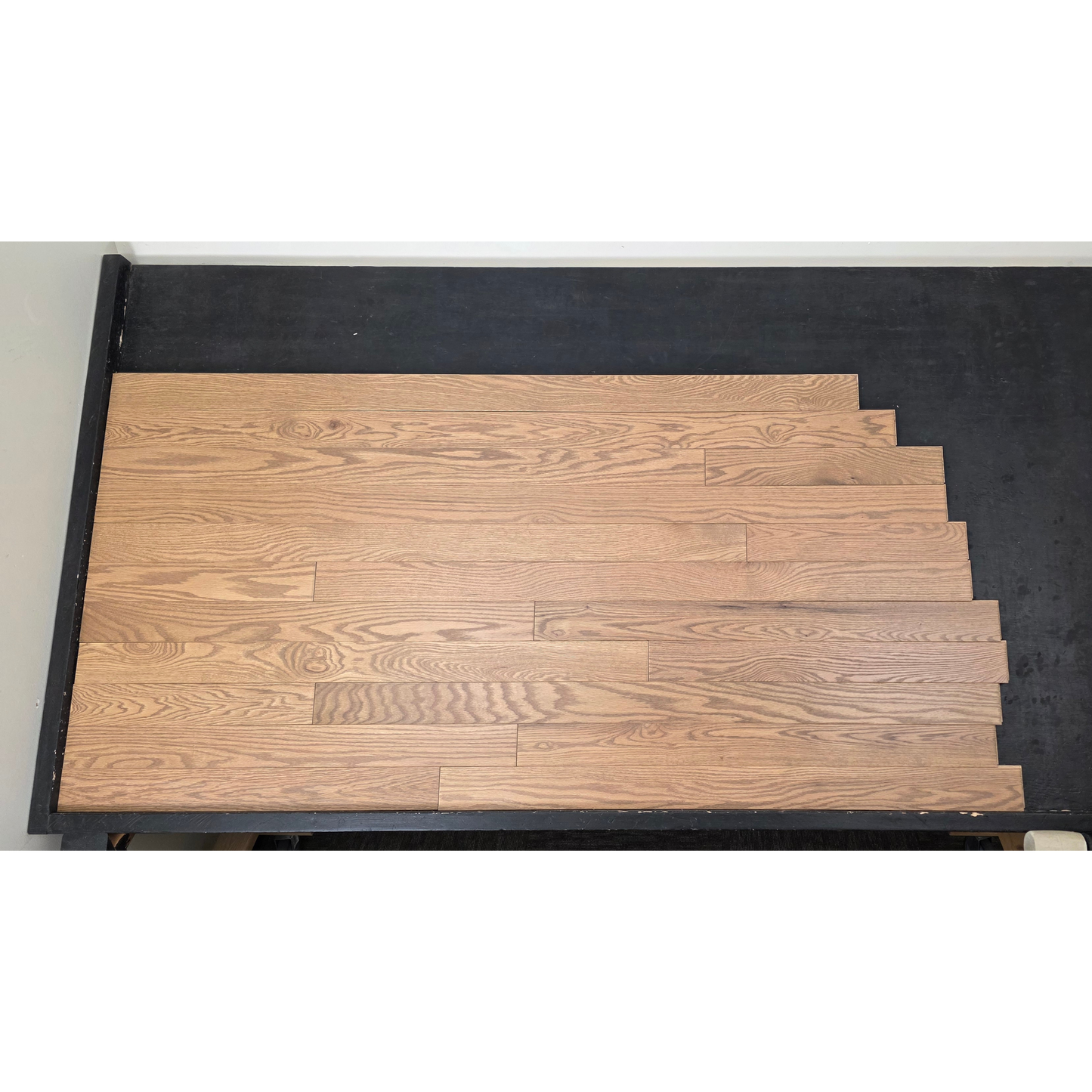 3 1/4" x 3/4" Solid Red Oak Marcy Hardwood Flooring. Shown on a black shooting table. Shot from center.