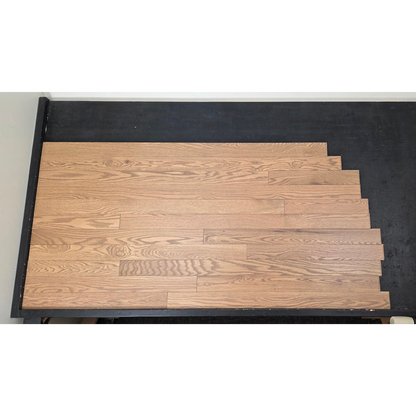 3 1/4" x 3/4" Solid Red Oak Marcy Hardwood Flooring. Shown on a black shooting table. Shot from center.