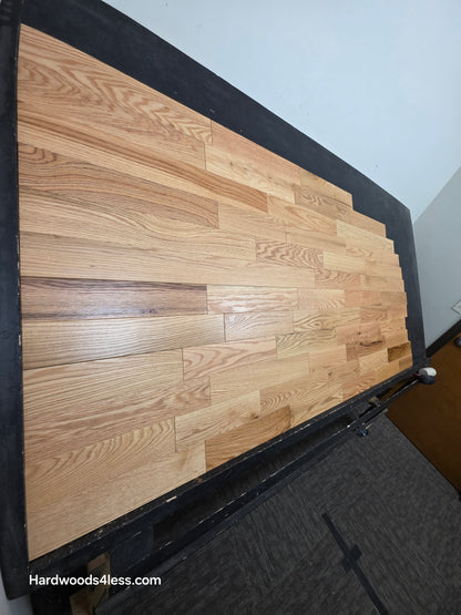 3 1/4" x 3/4" Solid Red Oak Natural Rustic Shorts Hardwood Flooring. Shown on a black shooting table. Shot from steep left. 