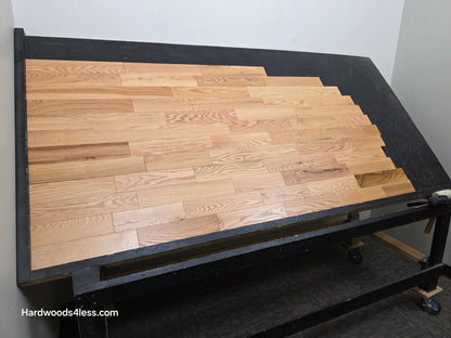 3 1/4" x 3/4" Solid Red Oak Natural Rustic Shorts Hardwood Flooring. Shown on a black shooting table. Shot from wide left.